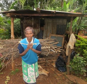 Cecily Muthoni with Grevillea prunnings from her farm. She mostly sources firewood from trees on her farm or from her neighbours’ farms. Photo: James Kinyua/World Agroforestry Centre