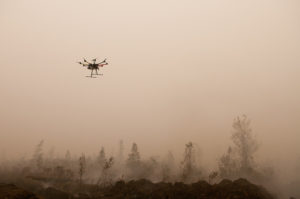 An Unmanned Aerial Vehicle (UAV) flies over burning peat. Outside Palangka Raya, Central Kalimantan. Photo by Aulia Erlangga/ CIFOR