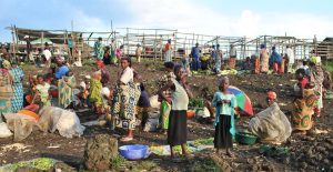 Women farmers trade at the evening market in Kitchanga, Masisi, North-Kivu, after a day in the field. Many members of the community are internally displaced and farming marginal land with no tenure security. Photo by E Smith Dumont.